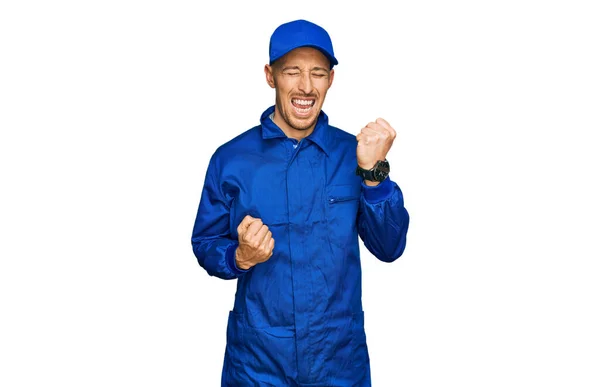 Bald Man Beard Wearing Builder Jumpsuit Uniform Celebrating Surprised Amazed — Stock Photo, Image