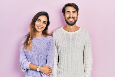 Mutlu ve havalı bir gülüşü olan gündelik kıyafetler giyen genç İspanyol çift. şanslı kişi. 