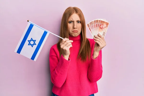 Junge Irin Mit Israel Flagge Und Schekel Banknoten Skeptisch Und — Stockfoto