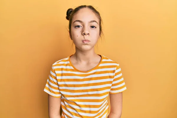 Beautiful Brunette Little Girl Wearing Casual Striped Shirt Puffing Cheeks — Stock Photo, Image