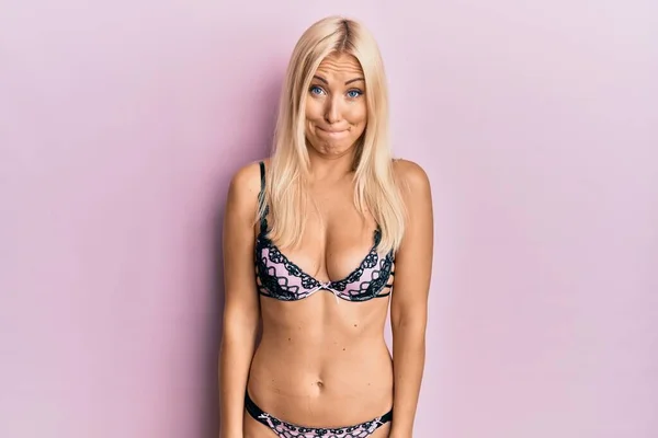 Young Blonde Woman Wearing Lingerie Puffing Cheeks Funny Face Mouth — Stock Photo, Image