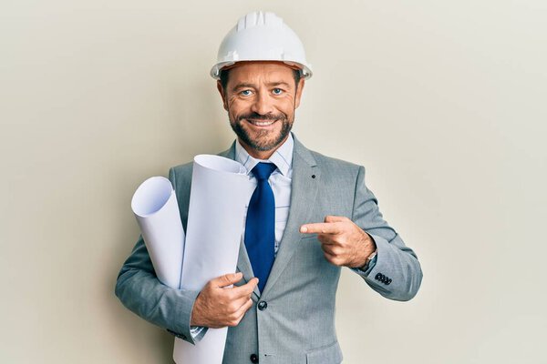 Middle Age Architect Man Wearing Safety Helmet Holding Blueprints Smiling Stock Image