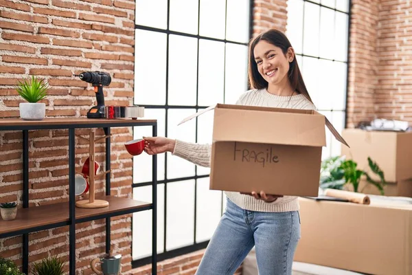 Young Woman Smiling Confident Unboxing Fragile Cardboard Box New Home — Fotografia de Stock