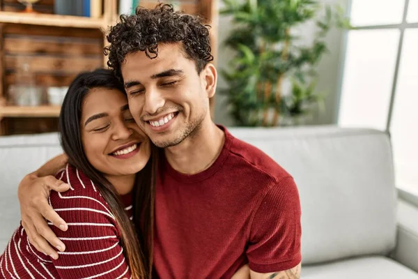 Young Latin Couple Smiling Happy Hugging Sitting Sofa Home — Stock Photo, Image