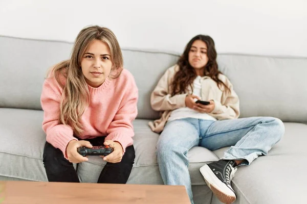 Menina Jogando Vídeo Game Sua Namorada Chato Usando Smartphone Casa — Fotografia de Stock