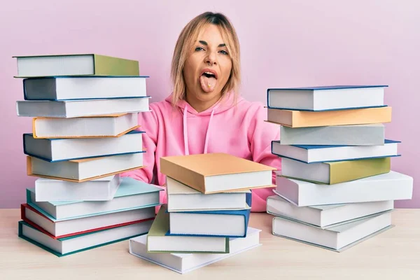 Young Caucasian Woman Sitting Table Books Sticking Tongue Out Happy — Stock Photo, Image