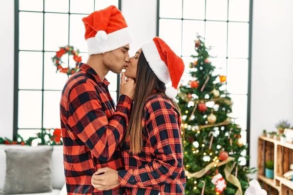 Young Latin Couple Kissing Hugging Standing Christmas Tree Home — Stock Photo, Image