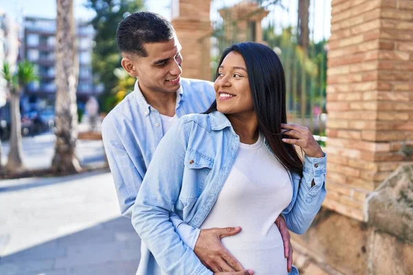 Young Latin Couple Expecting Baby Hugging Each Other Standing Street — Stockfoto