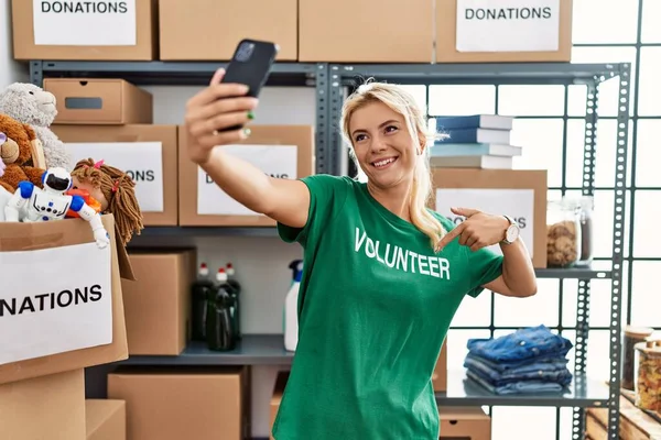 Young Blonde Volunteer Girl Smiling Happy Making Selfie Smartphone Charity — Stock Photo, Image