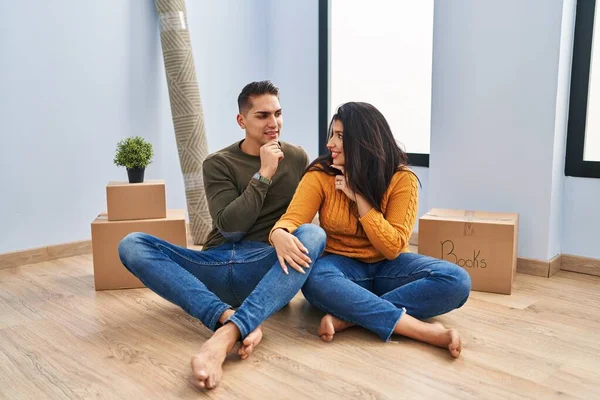 Young Couple Sitting Floor New Home Hand Chin Thinking Question — 스톡 사진