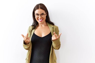 Young brunette woman standing over isolated background showing middle finger doing fuck you bad expression, provocation and rude attitude. screaming excited 