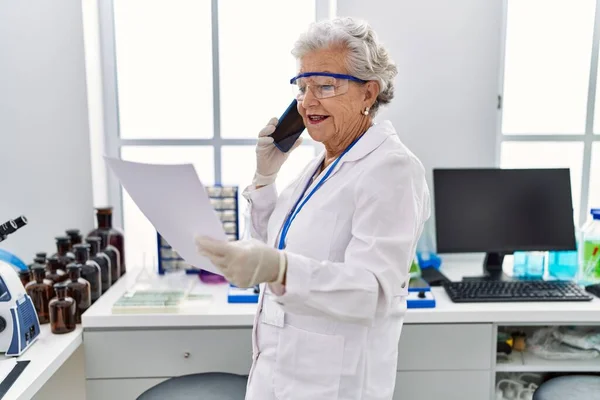 Senior Grey Haired Woman Wearing Scientist Uniform Talking Smartphone Laboratory — Stock Photo, Image