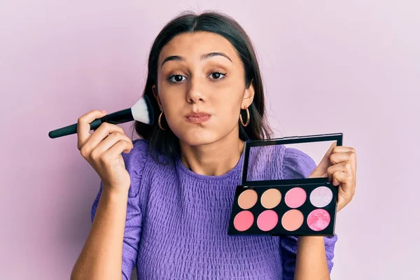 Mujer Hispana Joven Sosteniendo Cepillo Maquillaje Sonrojando Mejillas Con Cara — Foto de Stock