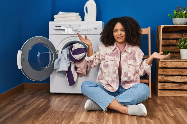 Young African American Woman Sitting Floor Doing Laundry Clueless Confused — Fotografia de Stock