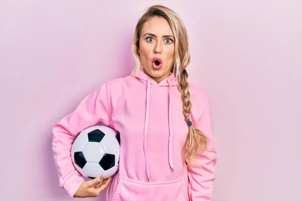 Beautiful Young Blonde Woman Holding Soccer Ball Scared Amazed Open — Stock Photo, Image