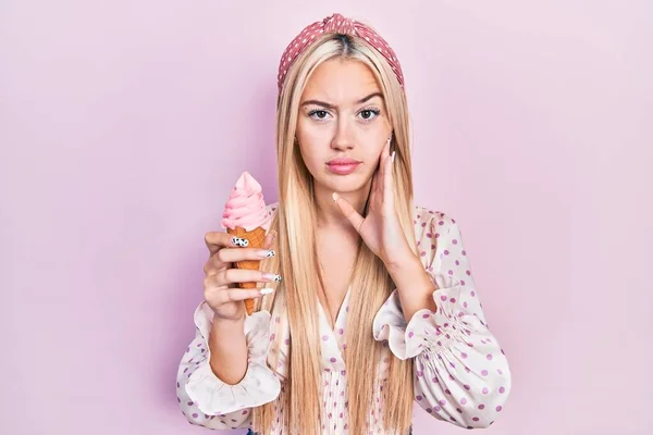 Young Blonde Girl Holding Ice Cream Skeptic Nervous Frowning Upset — Stock Photo, Image