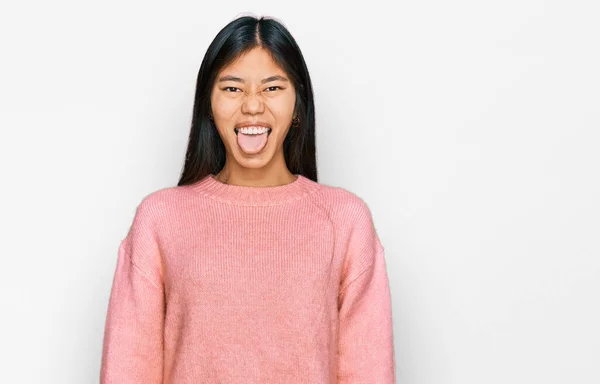 Beautiful Young Asian Woman Wearing Casual Winter Sweater Sticking Tongue — Stock Photo, Image