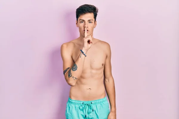 Young Hispanic Man Wearing Swimwear Shirtless Asking Quiet Finger Lips — Stock Photo, Image