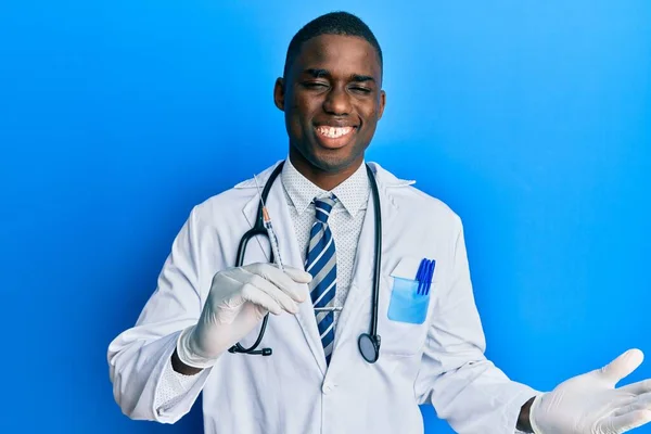 Young African American Doctor Man Holding Syringe Celebrating Victory Happy — стоковое фото
