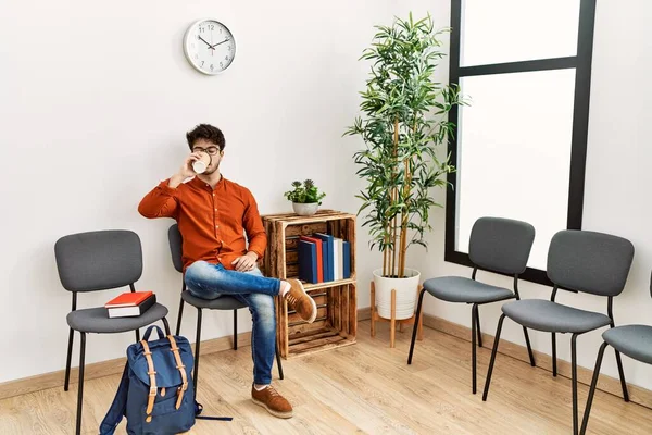 Young Hispanic Man Drinking Coffee Waiting Room — Stockfoto