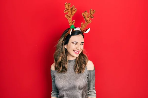 Young Hispanic Girl Wearing Deer Christmas Hat Looking Away Side — Stock fotografie