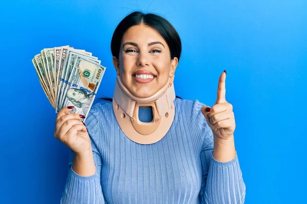 Beautiful Brunette Woman Wearing Cervical Collar Holding Insurance Money Smiling — Stock Photo, Image