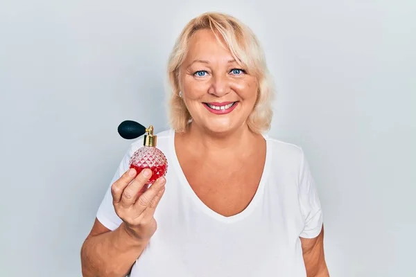 Middle Age Blonde Woman Holding Perfume Looking Positive Happy Standing — Stock Photo, Image