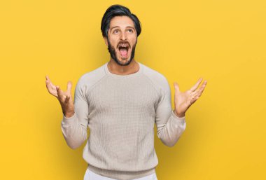 Gündelik kıyafetler giyen genç İspanyol adam deli gibi bağırıyor ve agresif bir ifade ve kollarla bağırıyor. hüsran kavramı. 