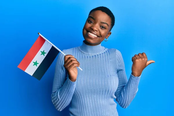 Young African American Woman Holding Syria Flag Pointing Thumb Side — Stock Photo, Image