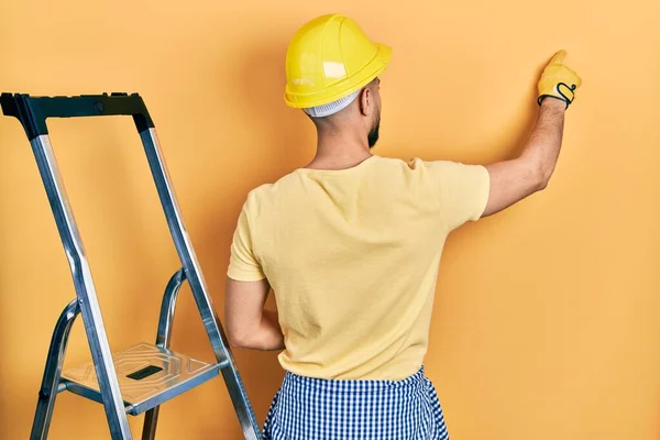 Handsome Man Beard Construction Stairs Wearing Hardhat Posing Backwards Pointing — Stock Photo, Image