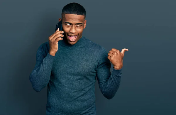 Young Black Man Having Conversation Talking Smartphone Pointing Thumb Side — Stockfoto