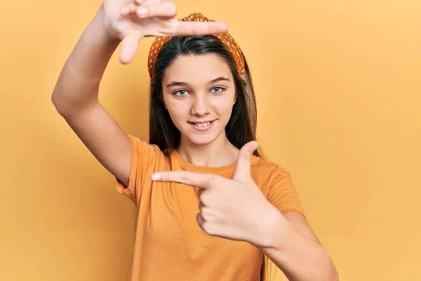 Young Brunette Girl Wearing Casual Orange Shirt Smiling Making Frame — Stock Photo, Image
