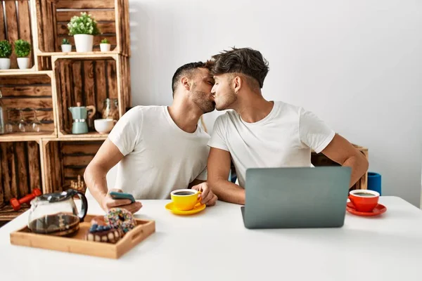 Two Hispanic Men Couple Having Breakfast Using Smartphone Laptop Home — Stock Photo, Image