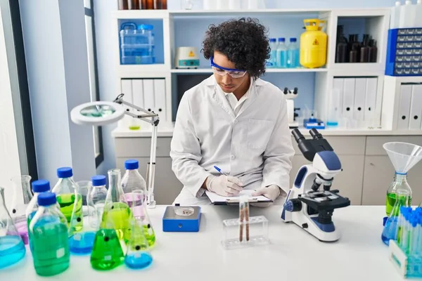 Young Hispanic Man Wearing Scientist Uniform Measuring Sample Laboratory — Stockfoto