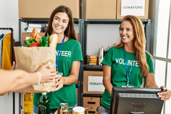 Mother Daughter Wearing Volunteer Uniform Holding Groceries Paper Bag Charity — Stock Photo, Image