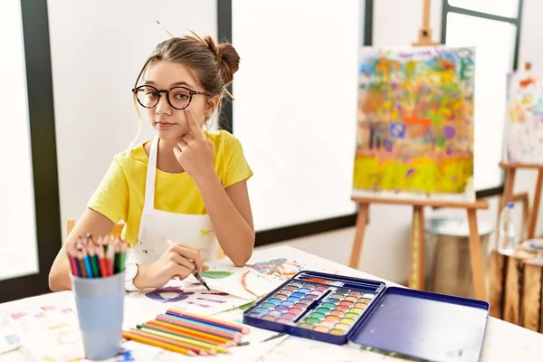 Young Brunette Teenager Art Studio Pointing Eye Watching You Gesture — Stock Photo, Image