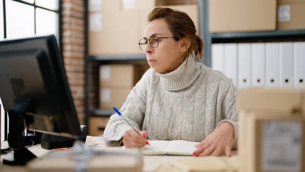 Middle Age Hispanic Woman Ecommerce Business Worker Writing Book Storehouse — Stock Photo, Image