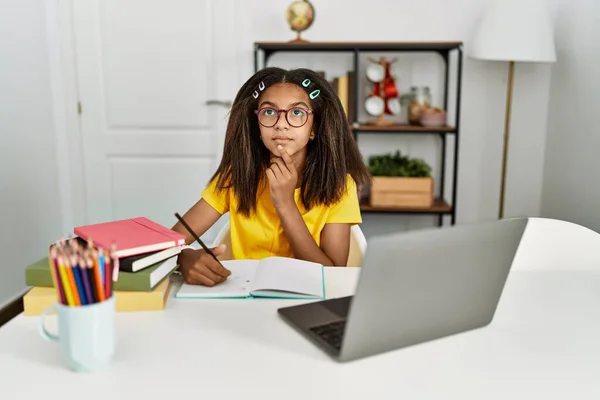 Young African American Girl Doing Homework Home Thinking Concentrated Doubt —  Fotos de Stock