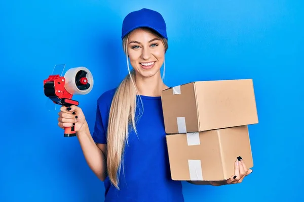 Young Caucasian Woman Holding Packages Packing Tape Smiling Happy Cool — Stockfoto