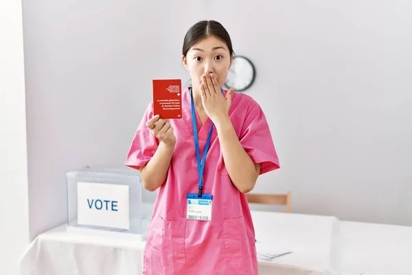 Молодая Азиатская Медсестра Выборах Держащая Швейцарский Паспорт Прикрывающий Рот Рукой — стоковое фото