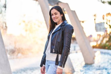 Sokakta kendinden emin gülümseyen genç bir kadın