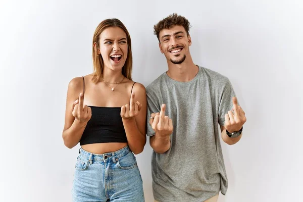 Young Beautiful Couple Standing Together Isolated Background Showing Middle Finger — 图库照片