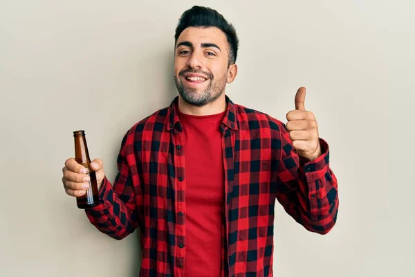 Joven Hombre Hispano Bebiendo Una Botella Cerveza Sonriendo Feliz Positivo — Foto de Stock