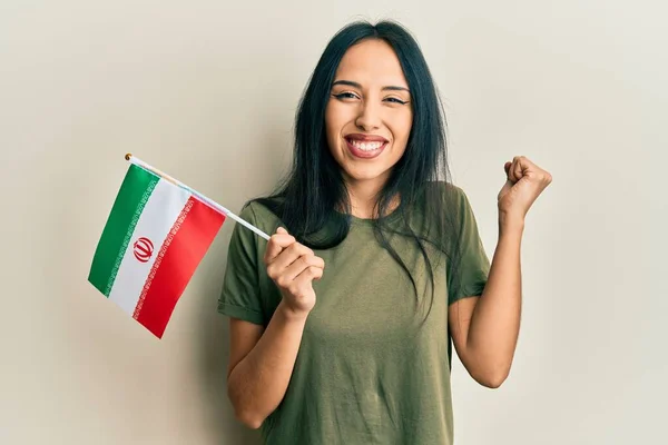 Young Hispanic Girl Holding Iran Flag Screaming Proud Celebrating Victory — Stock Photo, Image