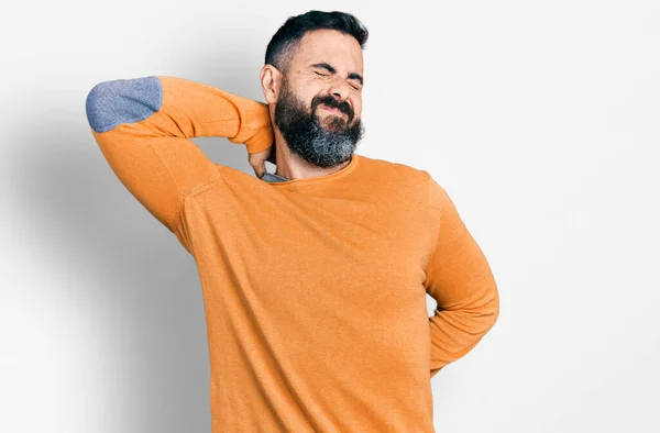 髭を生やしたヒスパニック系の男は 首の痛みの負傷 手で首に触れる 筋肉痛のカジュアルな冬のセーターを着て — ストック写真