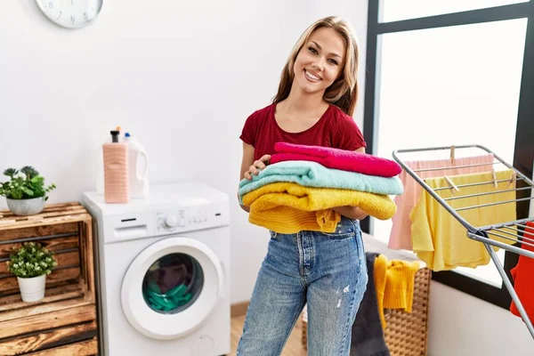 Young Caucasian Woman Holding Clean Laundry Looking Positive Happy Standing — Stock Photo, Image