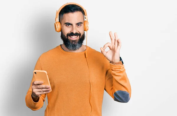 Hispanic Man Beard Using Smartphone Wearing Headphones Doing Sign Fingers — Stock Photo, Image