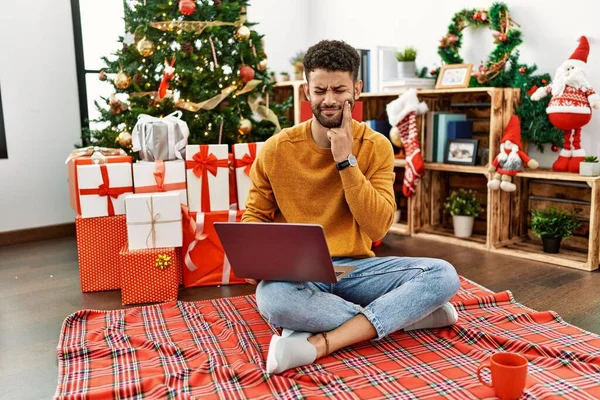Arab Young Man Using Laptop Sitting Christmas Tree Touching Mouth — Foto de Stock