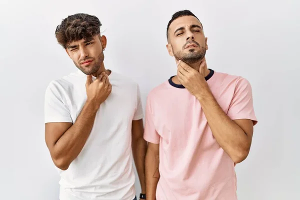 Young Gay Couple Standing Isolated Background Touching Painful Neck Sore — Stock Fotó