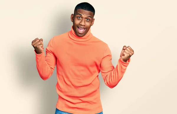 Young Black Man Wearing Orange Turtleneck Sweater Screaming Proud Celebrating — Stock Fotó